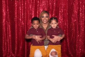 Mom with two children taking a photo in the photo booth