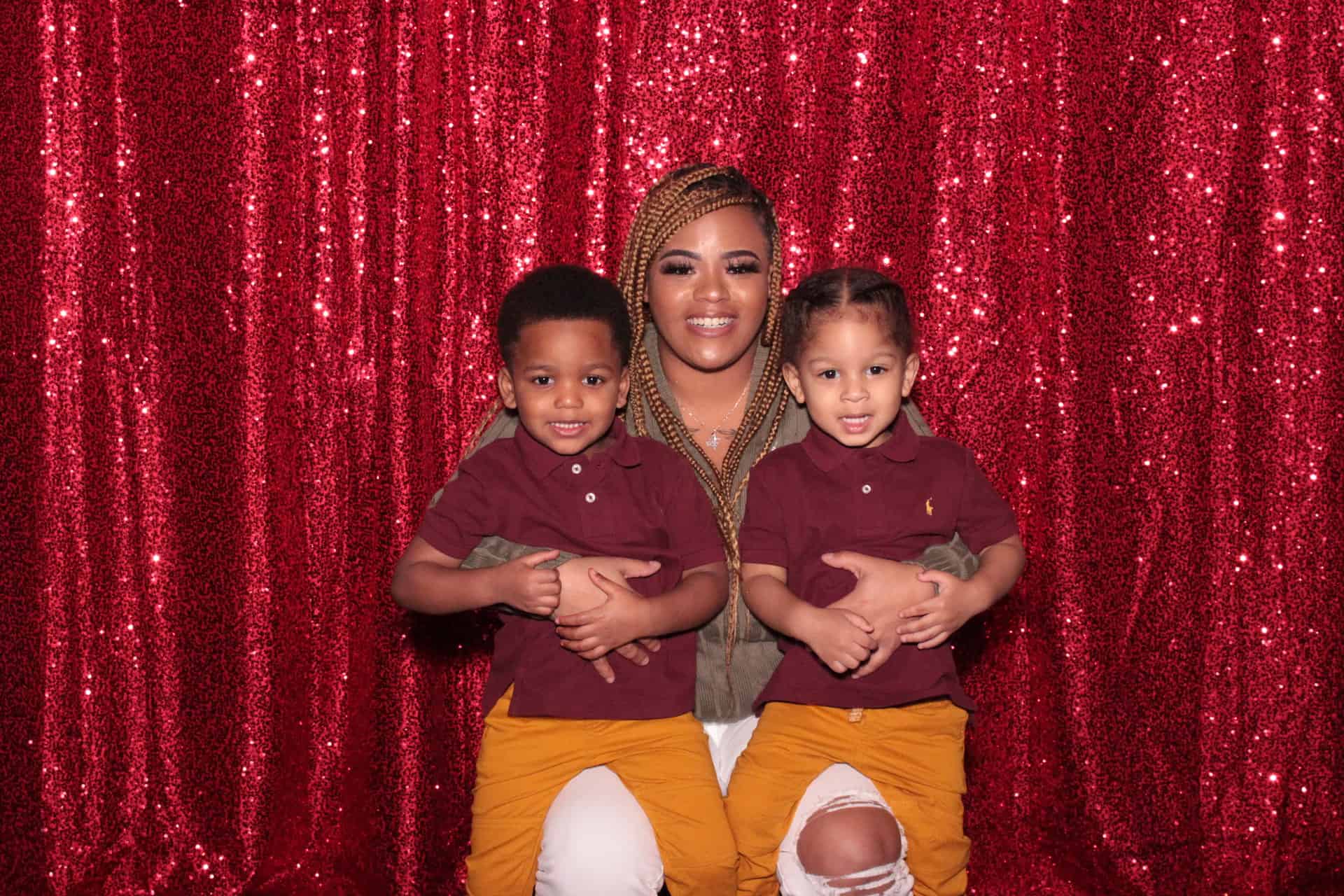 Mom with two children taking a photo in the photo booth