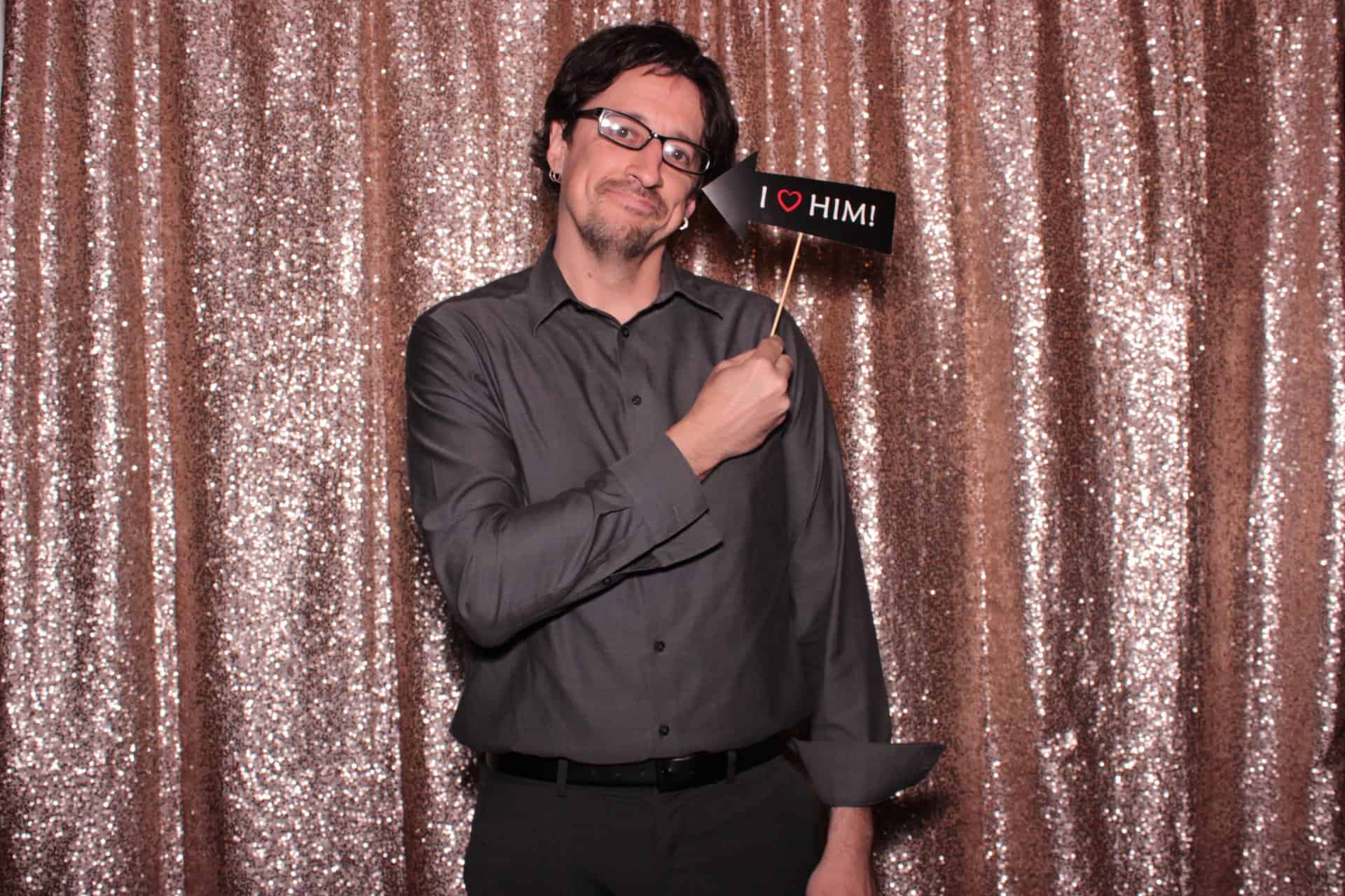 A man taking a selfie inside a photobooth