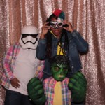 Family taking a photo inside a photobooth with props