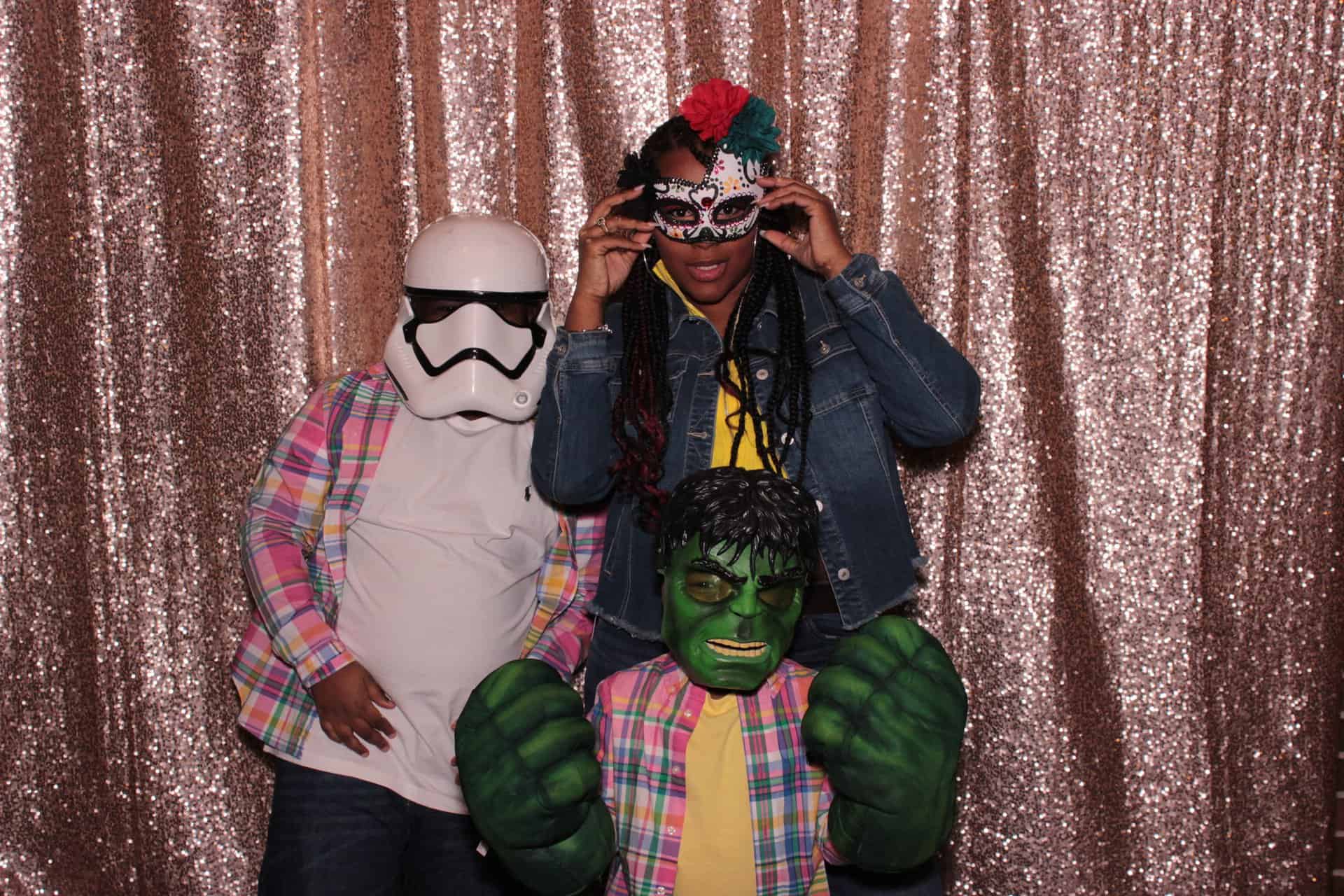 Family taking a photo inside a photobooth with props