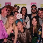 Lights Camera Fun Photo Booth in Chicago - hero image depicting smiling people with photo props taking a fun picture