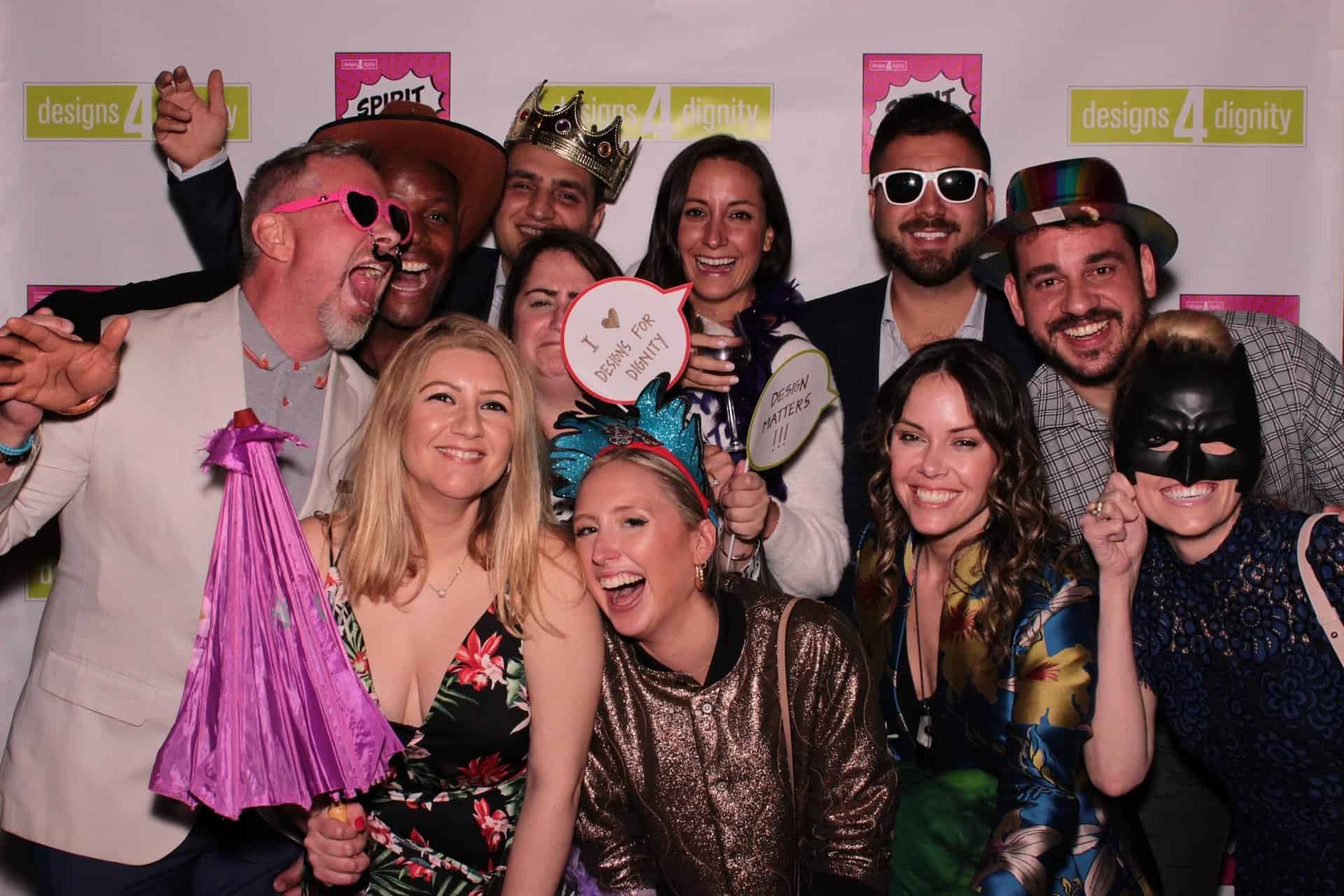 Lights Camera Fun Photo Booth in Chicago - hero image depicting smiling people with photo props taking a fun picture